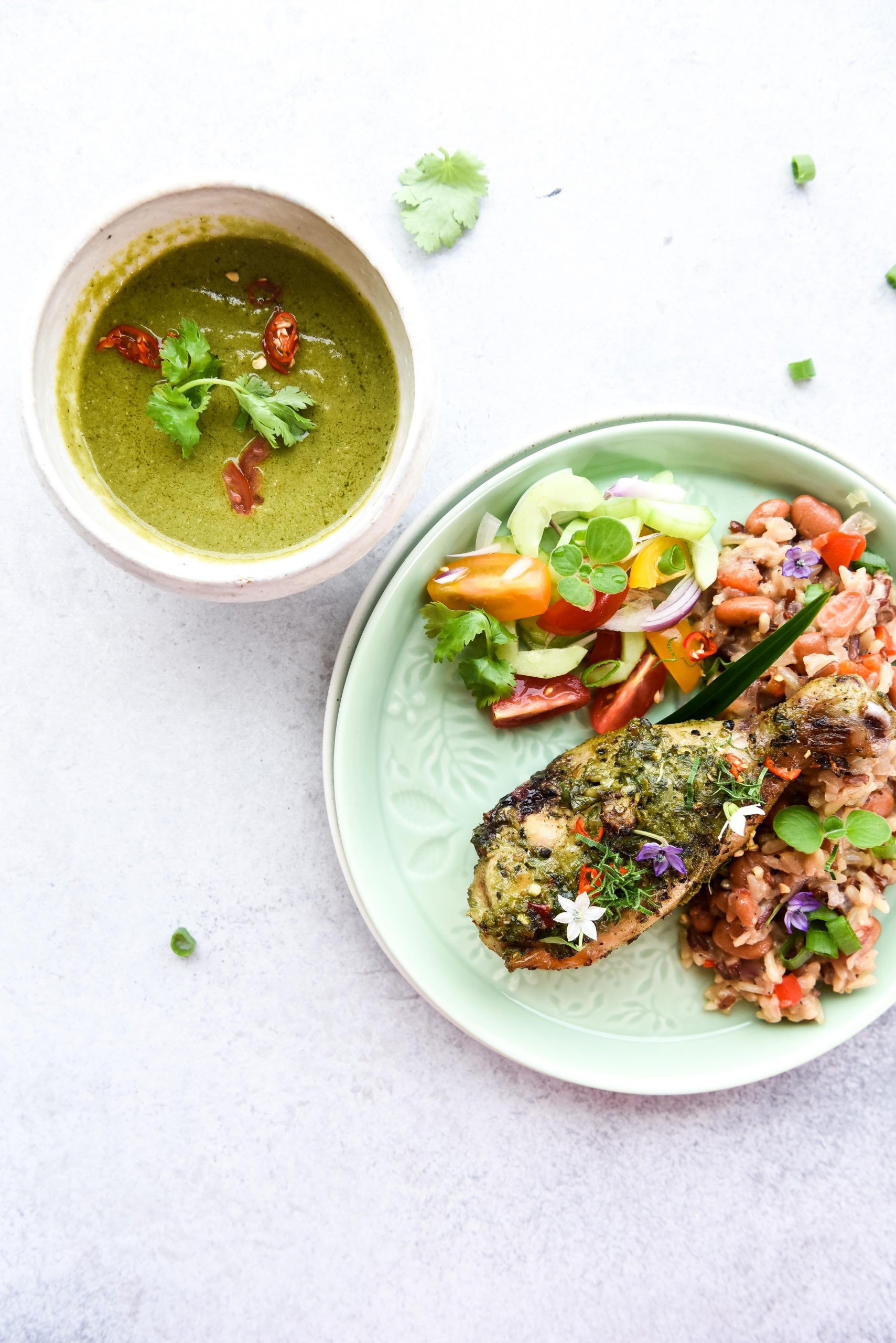 White bowl, green sauce, chicken drumstick